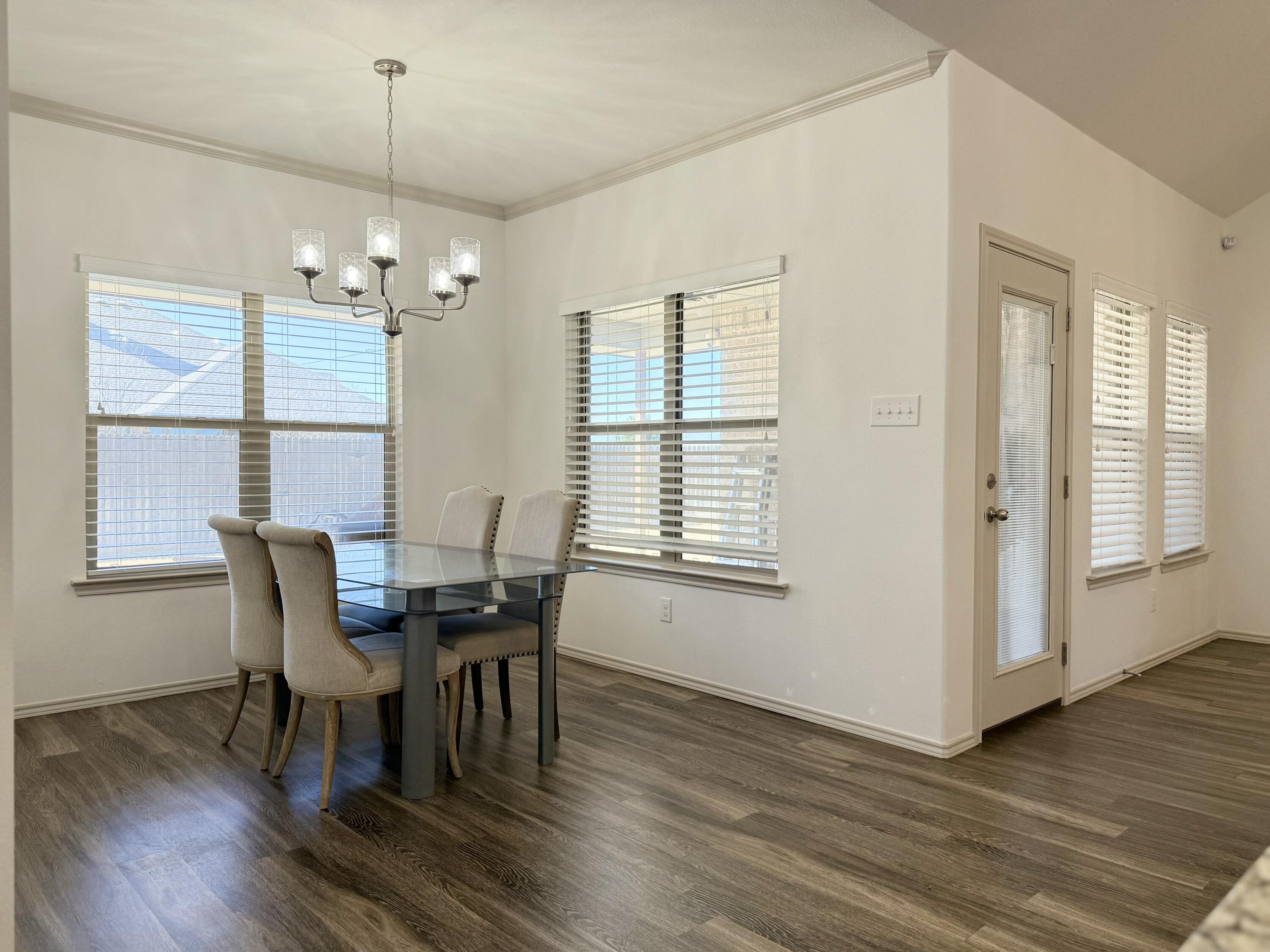 12202 Ithaca Avenue Lubbock, TX 79423 - Photo 8 of 28 a view of a dining room with furniture window and wooden floor