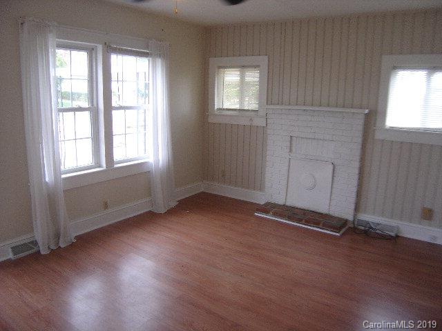 575 State Street Marion, NC 28752 - Photo 2 of 18 an empty room with wooden floor and windows