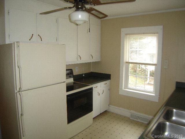 575 State Street Marion, NC 28752 - Photo 3 of 18 a kitchen with a refrigerator and a window