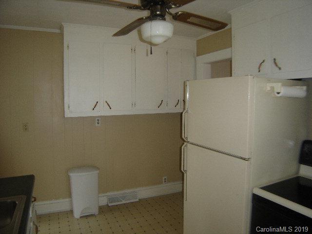 575 State Street Marion, NC 28752 - Photo 4 of 18 a room with a refrigerator and cabinets