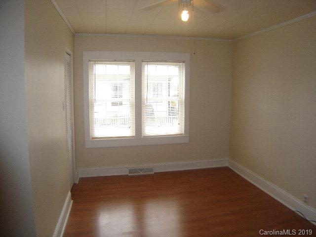 575 State Street Marion, NC 28752 - Photo 10 of 18 an empty room with wooden floor and windows