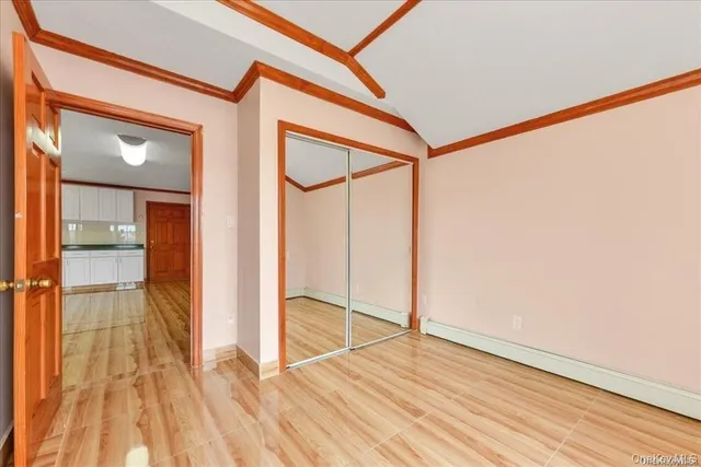 a view of a room with wooden floor and a window