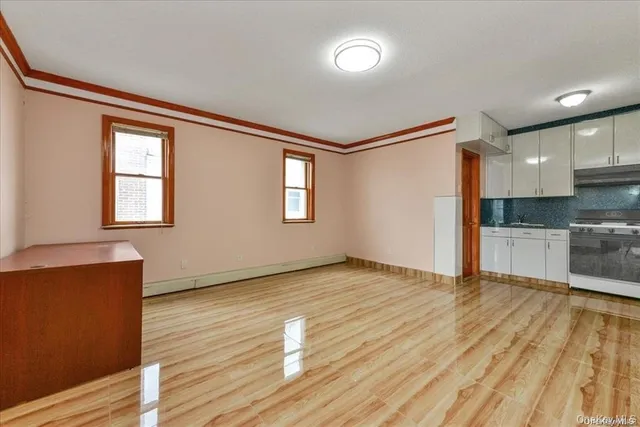 a view of kitchen with wooden floor electronic appliances and window