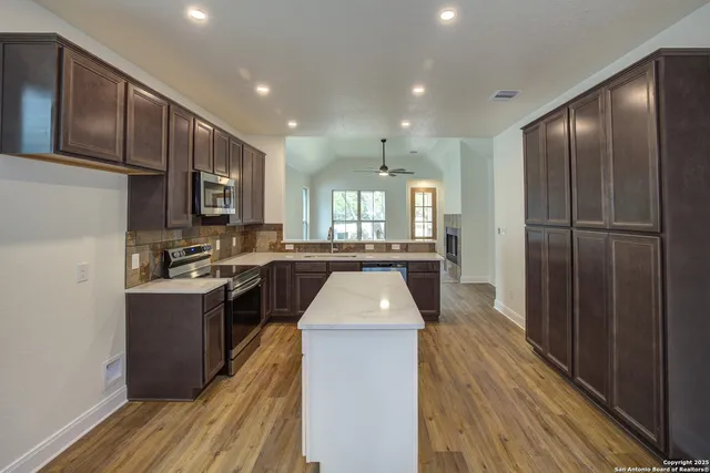 a kitchen with a refrigerator and a sink