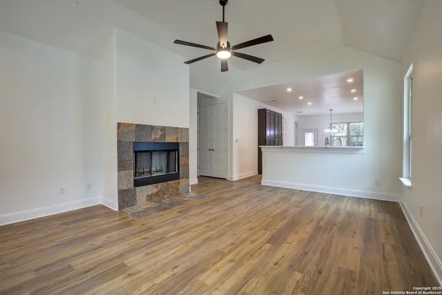 a view of a livingroom with a ceiling fan and window