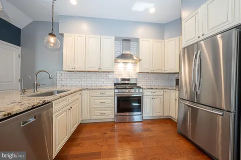 a kitchen with appliances cabinets and a stove top oven