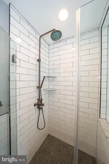 a utility room with wooden floor washer and dryer