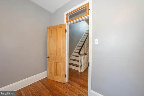 a view of a room with wooden floor