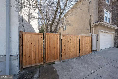 a view of a house with a wooden fence
