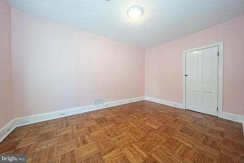 a view of a chair and table in backyard of the house