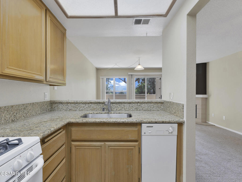 2731 Erringer Road, Unit 28 Simi Valley, CA 93065 - Photo 18 of 30 a kitchen with a sink stove and cabinets
