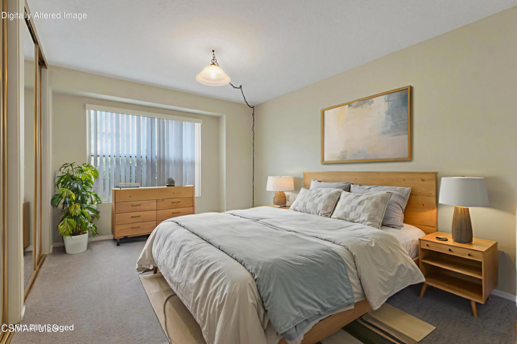 2731 Erringer Road, Unit 28 Simi Valley, CA 93065 - Photo 24 of 30 a bedroom with a bed and a chandelier