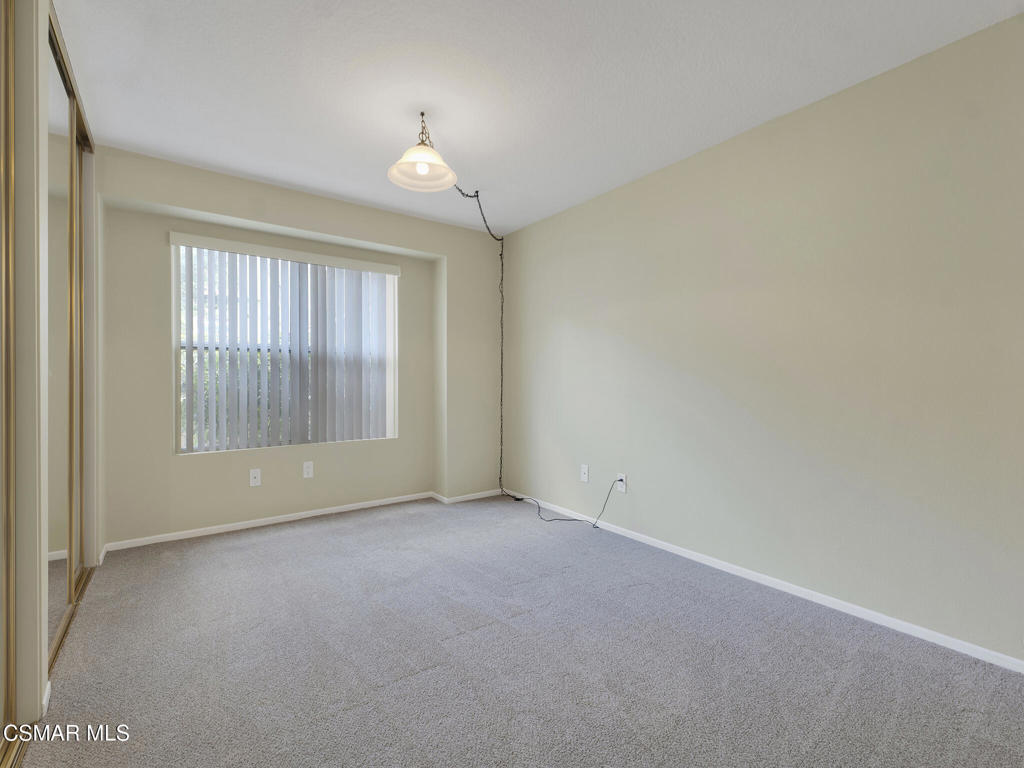 2731 Erringer Road, Unit 28 Simi Valley, CA 93065 - Photo 25 of 30 an empty room with windows and chandelier fan