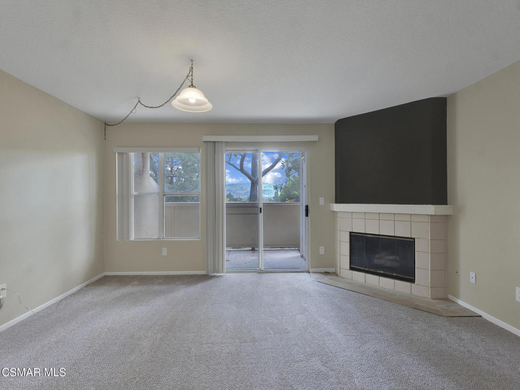 2731 Erringer Road, Unit 28 Simi Valley, CA 93065 - Photo 10 of 30 an empty room with fireplace and windows