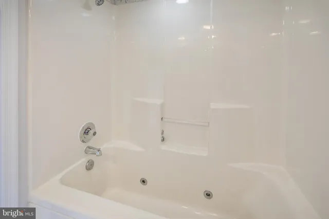 a white bath tub sitting in a bathroom