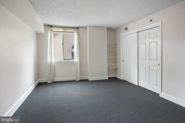 a view of empty room with closet area
