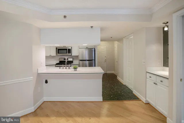 a view of kitchen with cabinets