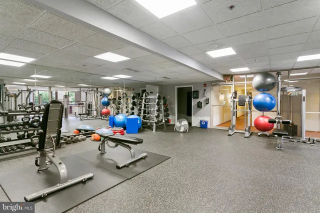 a living room with furniture a table and wooden floor