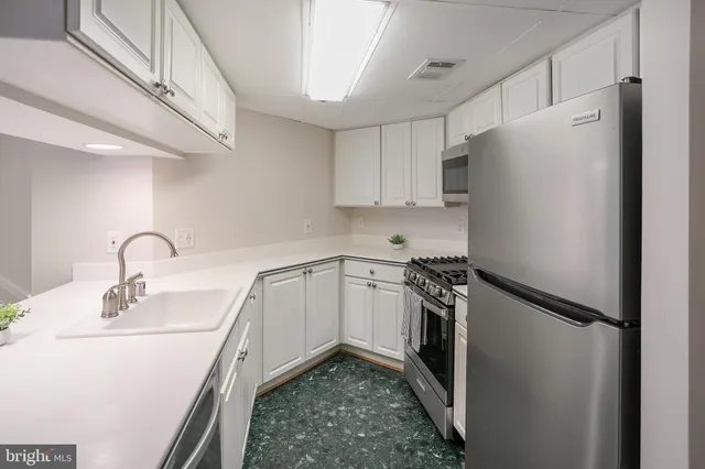 a kitchen with a sink appliances and cabinets