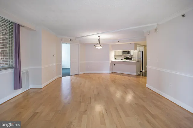 a big room with wooden floor and windows