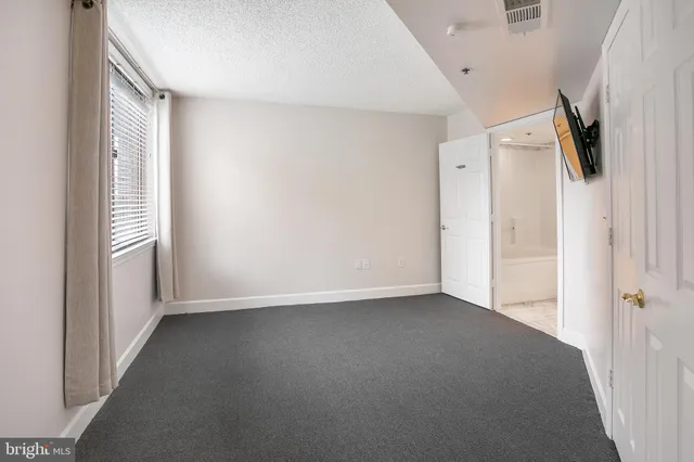 a view of a hallway with a kitchen