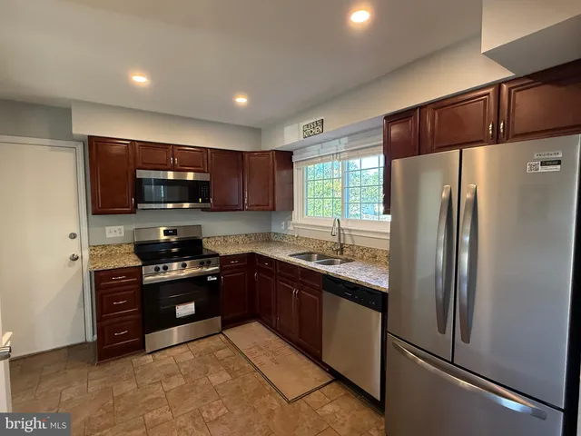 a view of back yard of the house along with trees