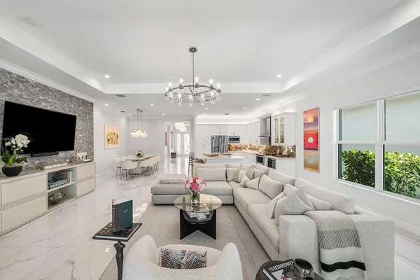 a living room with furniture and a chandelier