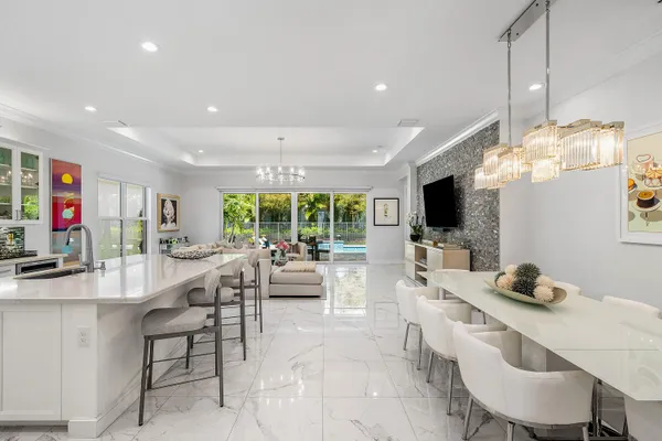 a kitchen with stainless steel appliances a sink stove and cabinets