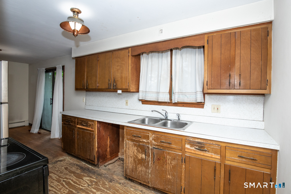 64 Somer Drive Meriden, CT 06451 - Photo 14 of 28 a kitchen with stainless steel appliances granite countertop a sink stove and cabinets