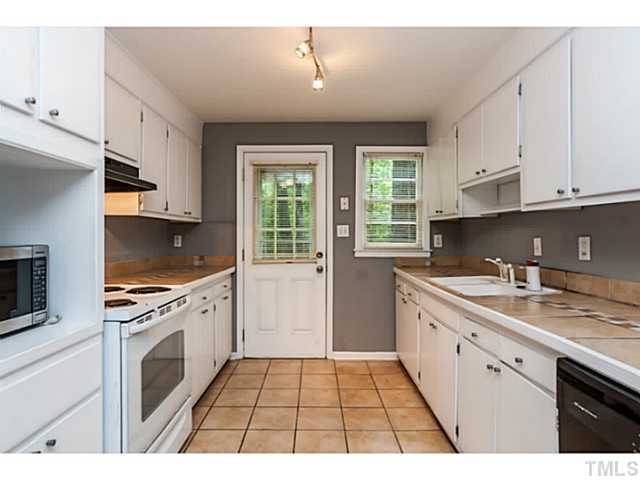 1731 Euclid Road Durham, NC 27713 - Photo 11 of 25 a kitchen with a sink a stove and cabinets