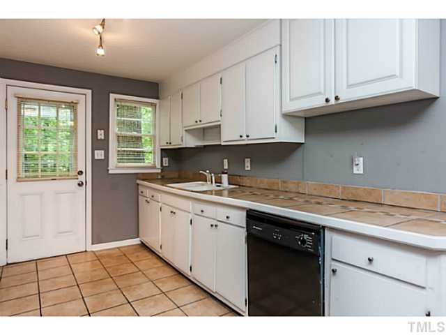 1731 Euclid Road Durham, NC 27713 - Photo 12 of 25 a kitchen with granite countertop a sink window and cabinets