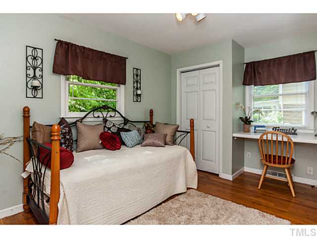 1731 Euclid Road Durham, NC 27713 - Photo 18 of 25 a bedroom with a bed a table and a large window