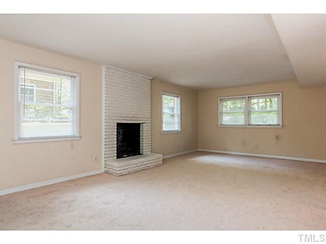 1731 Euclid Road Durham, NC 27713 - Photo 5 of 25 a view of an empty room with a window and a fireplace
