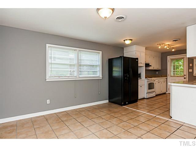1731 Euclid Road Durham, NC 27713 - Photo 10 of 25 a kitchen with stainless steel appliances kitchen island granite countertop a refrigerator and a sink