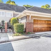 a front view of a house with a yard and potted plants