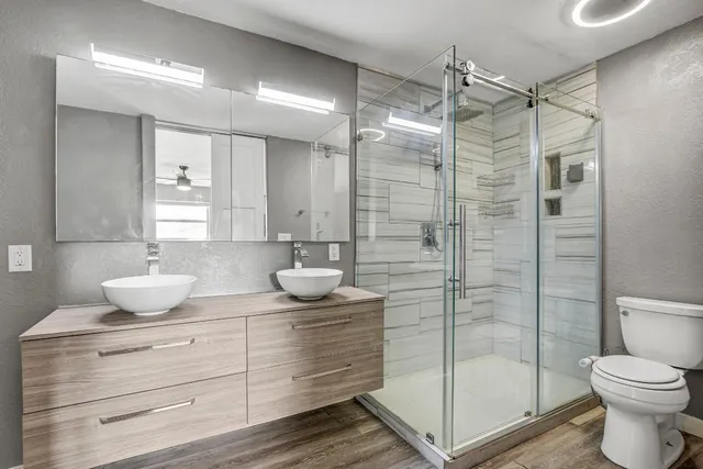 a bathroom with a shower sink and mirror