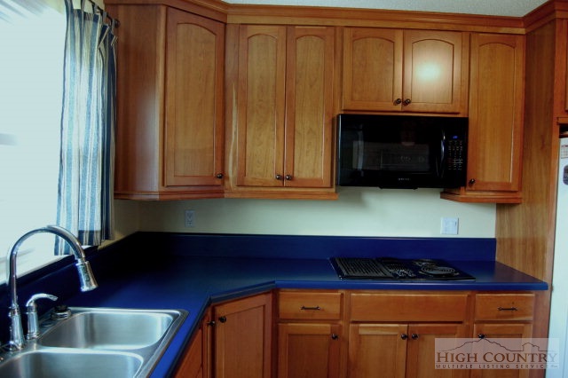 393 Harrison Road Boone, NC 28607 - Photo 25 of 28 a kitchen with granite countertop a sink and cabinets