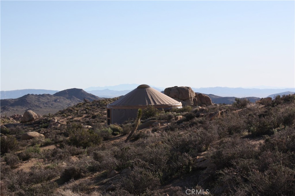 52588 Blackbrush Road Landers, CA 92285 - Photo 6 of 8 a view of a house with a mountain