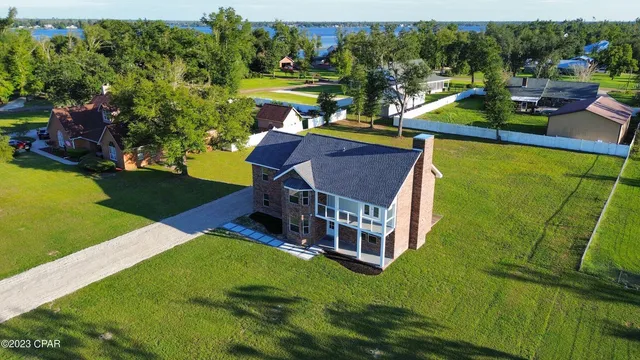 an aerial view of a house with swimming pool garden and outdoor seating