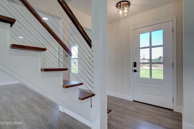 a view of entryway and hall with wooden floor