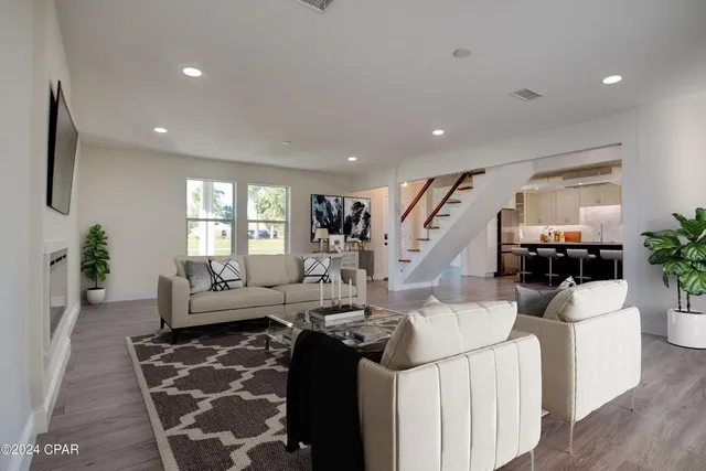 a living room with furniture and wooden floor