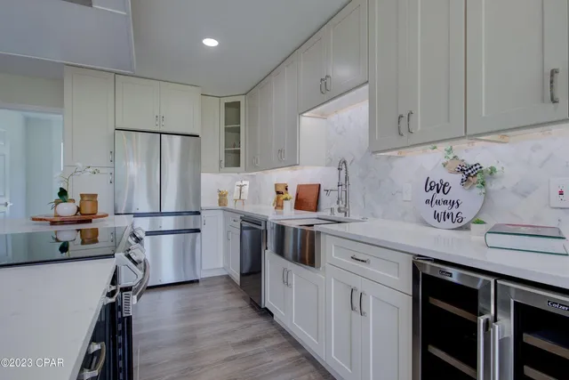 a kitchen with stainless steel appliances a stove a sink and a refrigerator