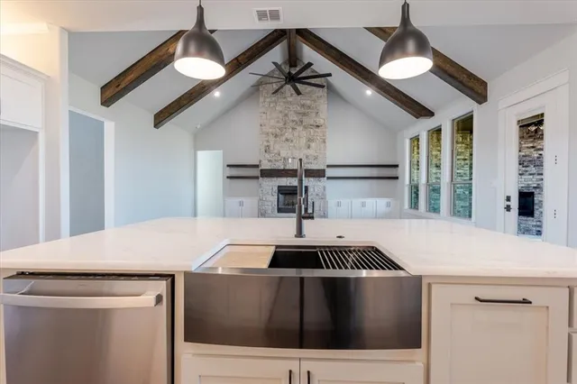 a kitchen with a sink a stove and a chandelier