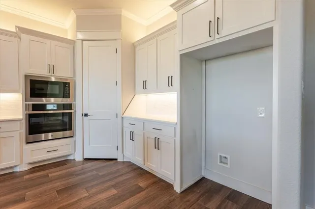 a view of a kitchen with refrigerator and oven