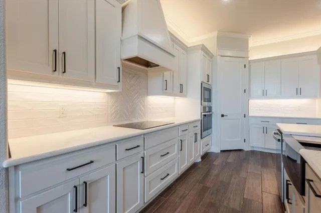 a kitchen with sink cabinets and wooden floor