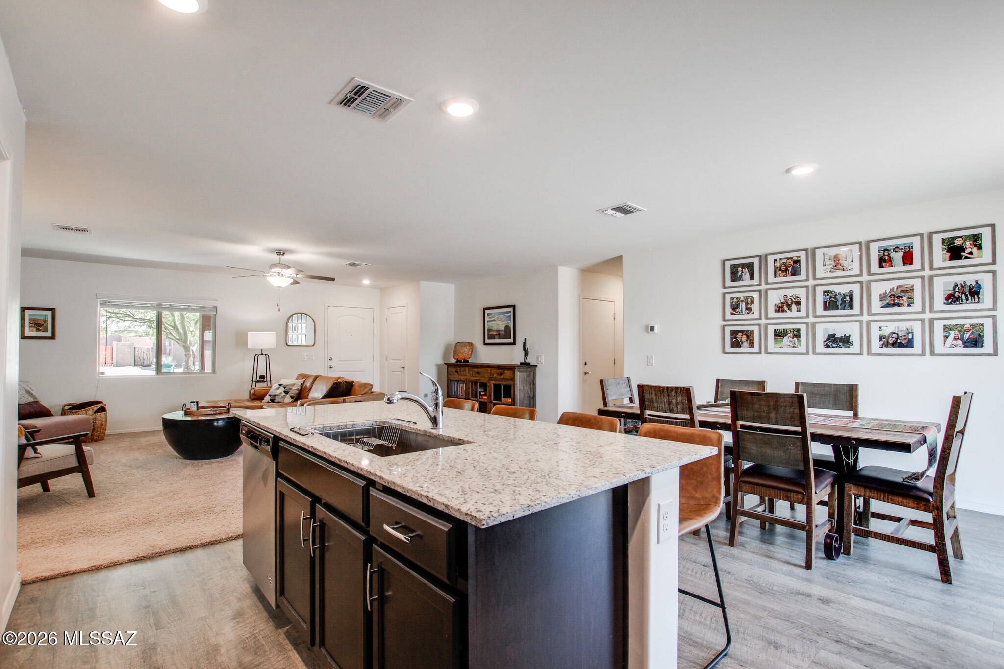 7056 South Draper Road Tucson, AZ 85757 - Photo 9 of 22 a view of a a dining room with furniture window and wooden floor