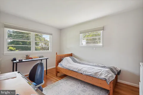 a bedroom with a bed and a desk