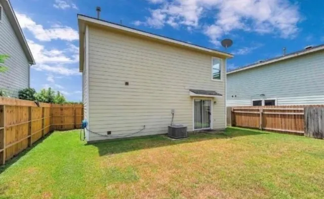 a view of a backyard with wooden fence