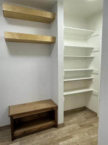 a room with a closet and wooden floor