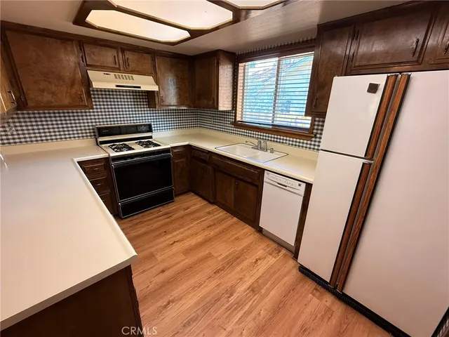 a kitchen with granite countertop a refrigerator and a stove
